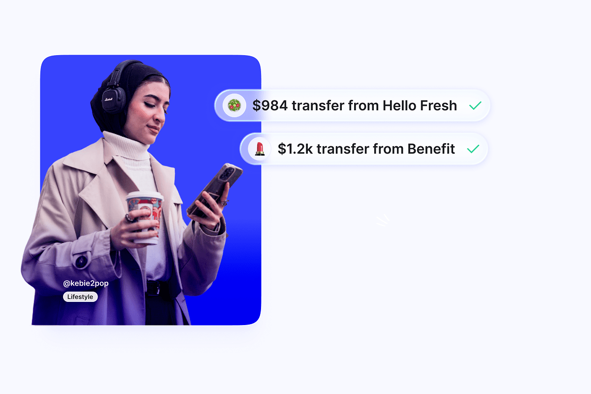 Illustration showing a creator looking down smiling at their phone: they've received two notification of payment from collabs, via Upfluence Pay.